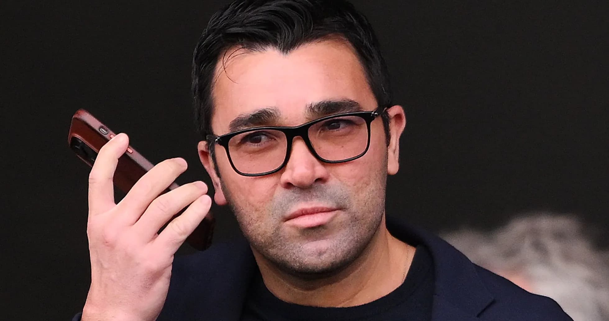 Person holding a phone, looking intently