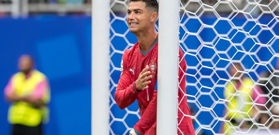 Cristiano Ronaldo gesturing near goalpost during match