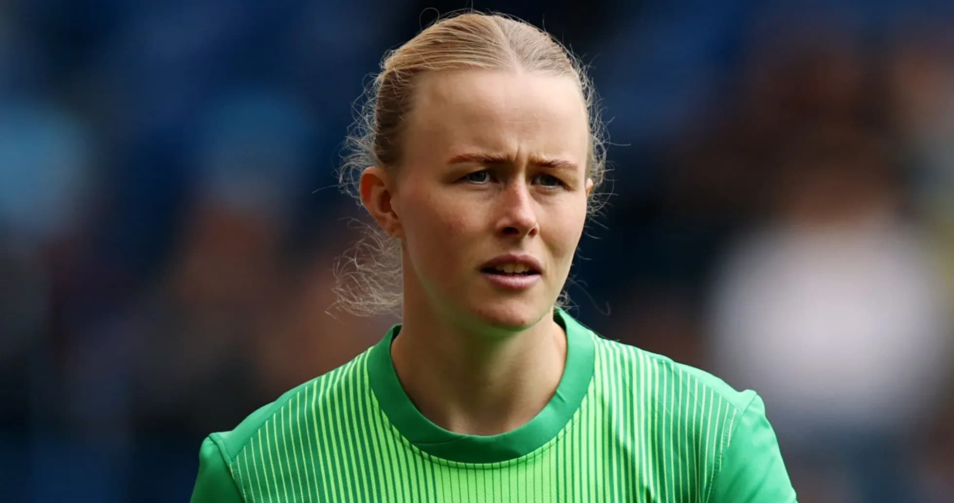 Goalkeeper in green uniform during warm-up