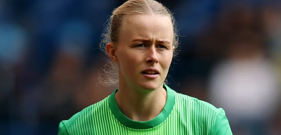 Goalkeeper in green uniform during warm-up
