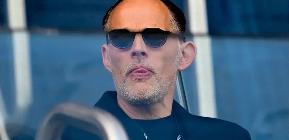 Man in sunglasses watching from a balcony