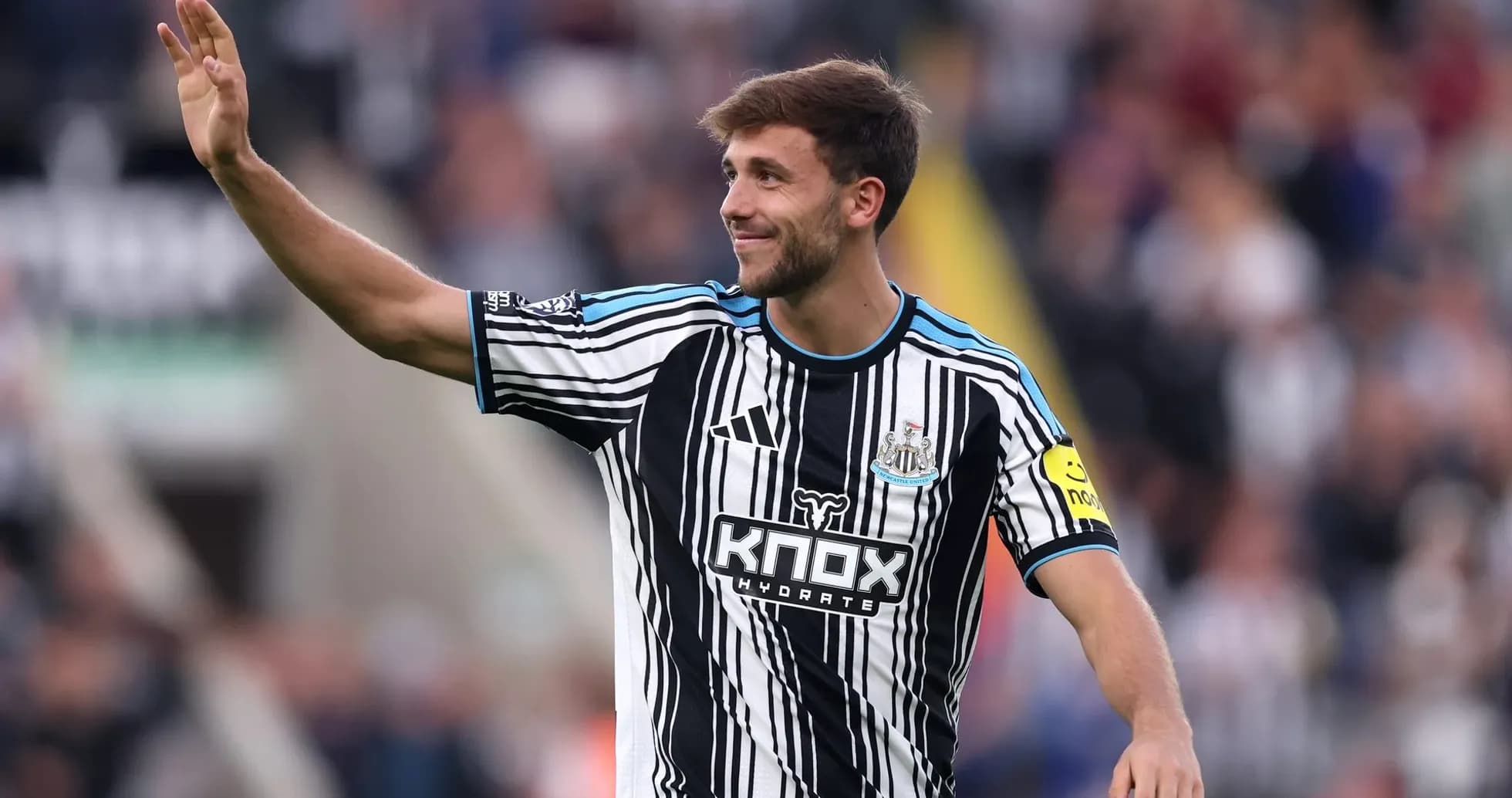 Newcastle player waving to fans during match
