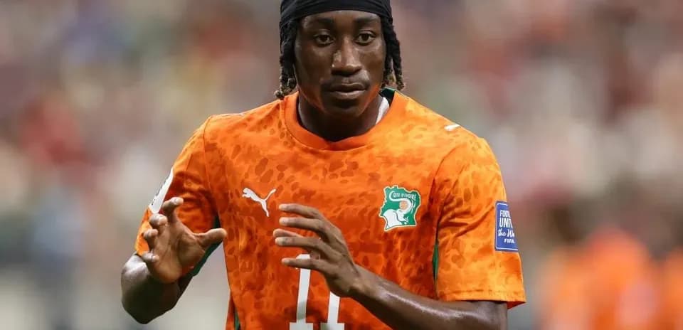 Player in orange jersey warming up on field