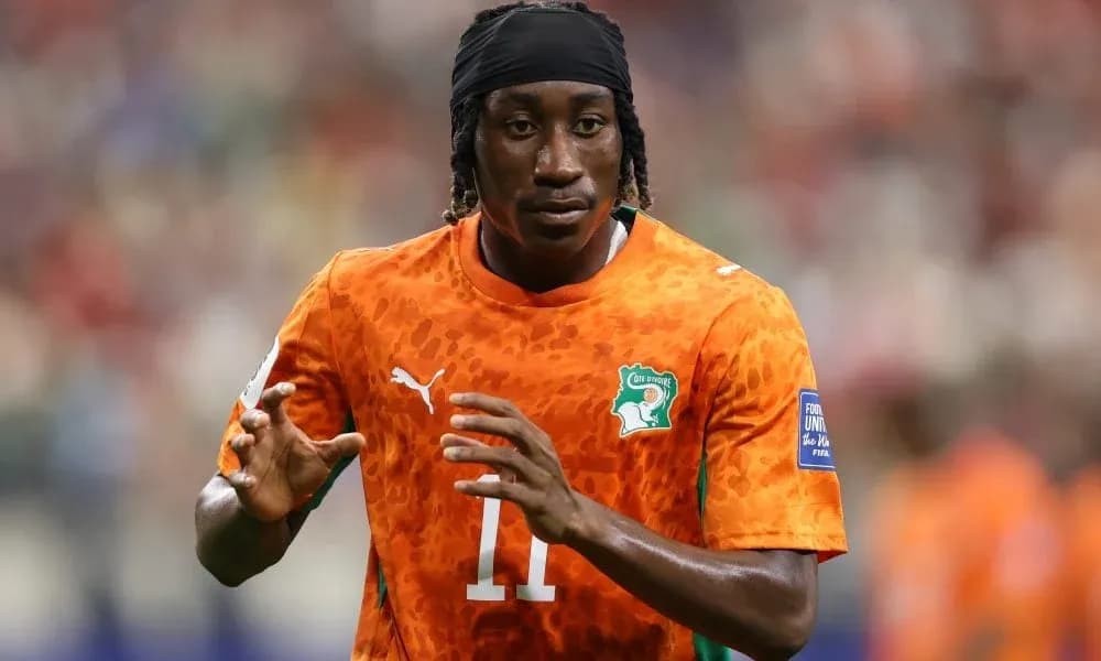 Player in orange jersey warming up on field