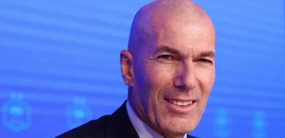 Man smiling at press conference with blue background