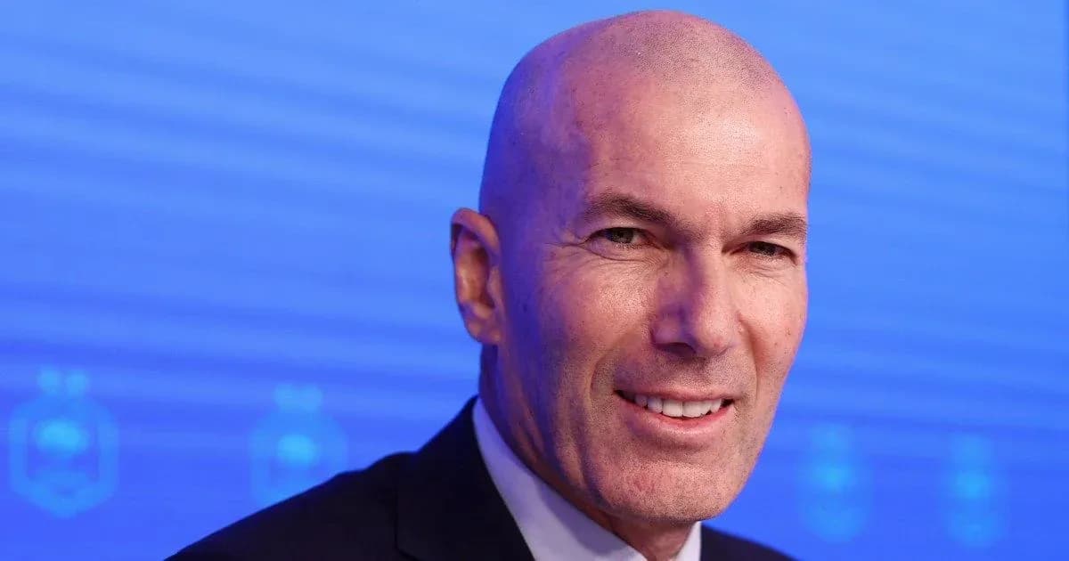 Man smiling at press conference with blue background