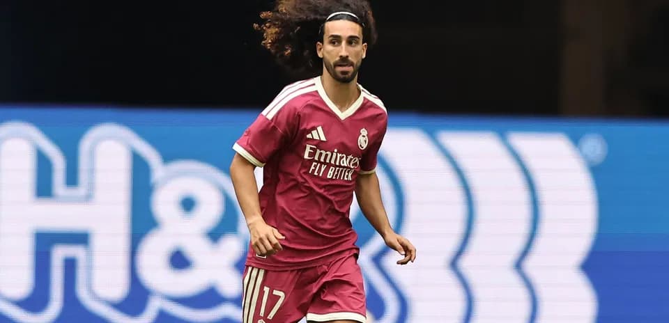Player running in pink Real Madrid jersey on field