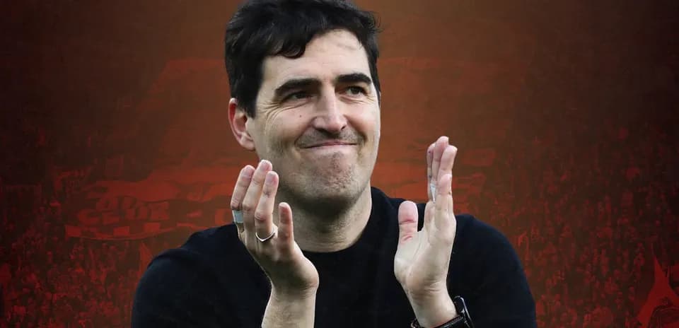 Coach applauding fans in stadium during match