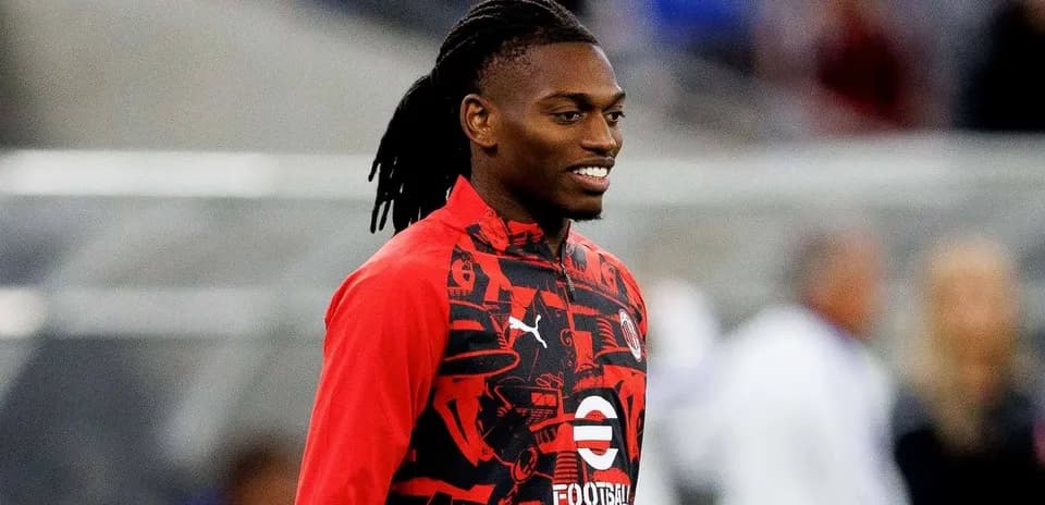 Player in red training gear smiling before match