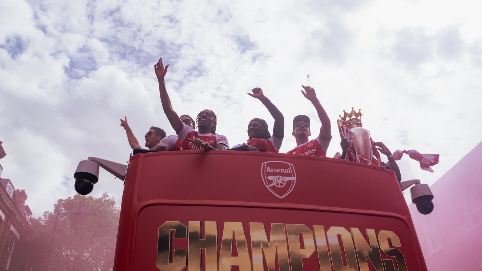 Arsenal players celebrating on victory parade bus