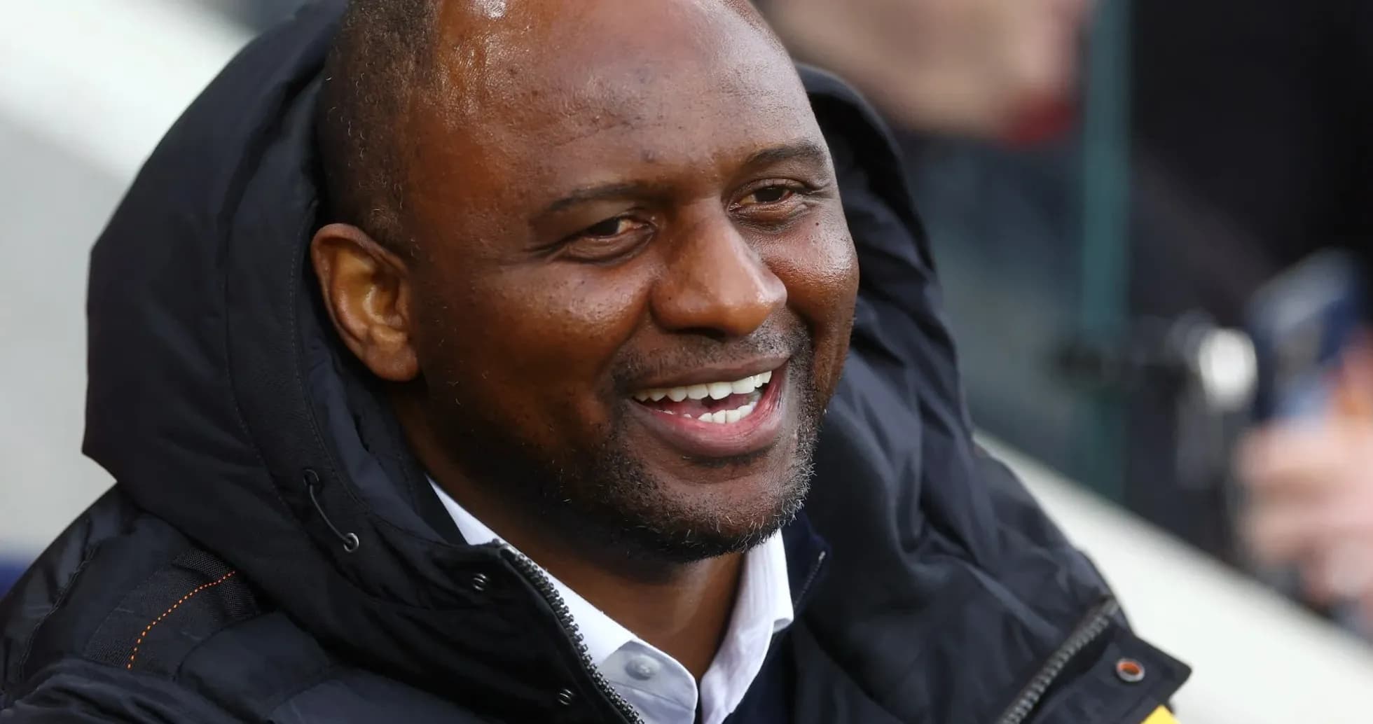 Man smiling in a black jacket at event