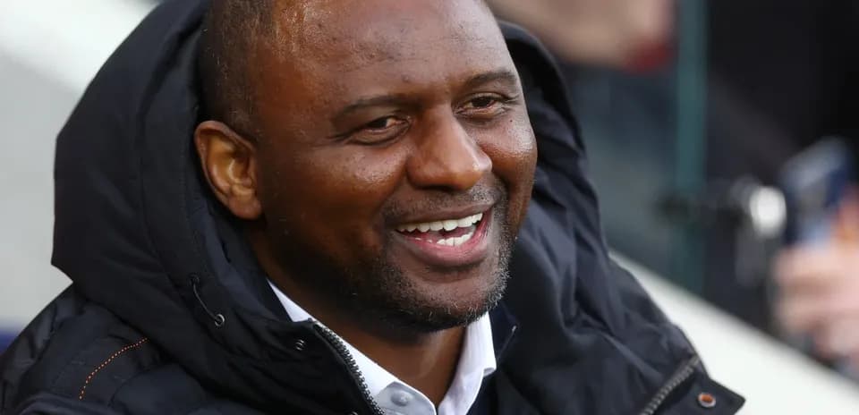 Man smiling in a black jacket at event