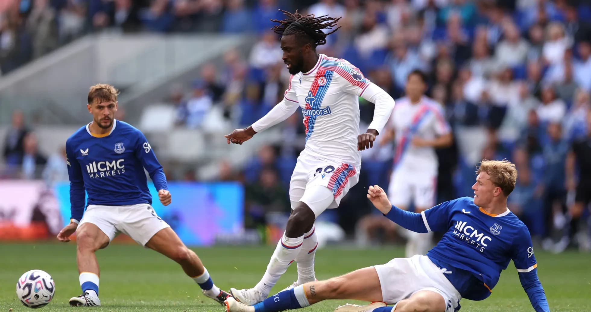 Player dribbling past two opponents during match