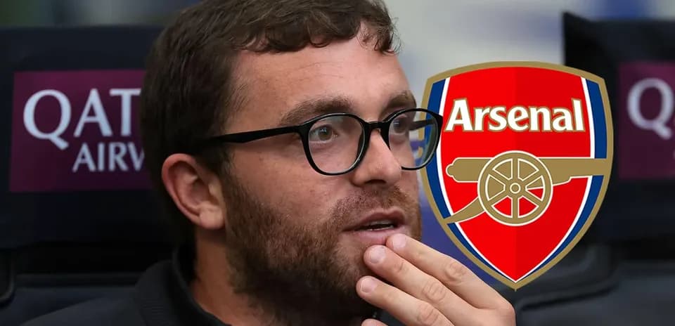 Person with glasses sitting near Arsenal logo