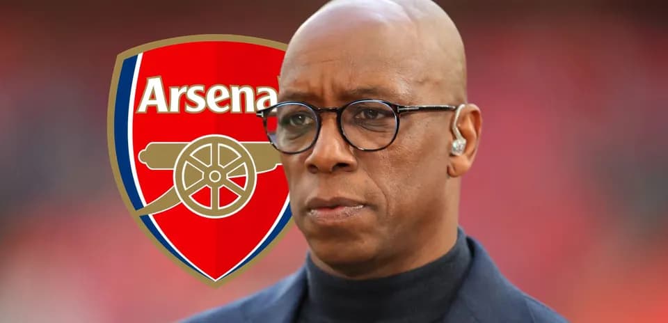 Person with glasses in front of Arsenal logo