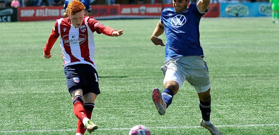 Players competing for the ball in football match