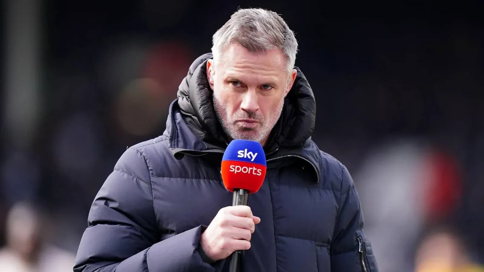 Presenter speaking into microphone on sports broadcast