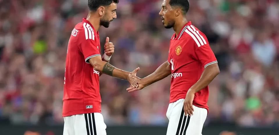 Two Manchester United players discussing on the field