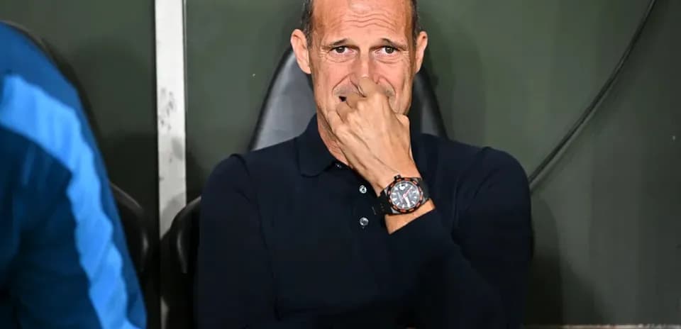 Coach seated on bench during match contemplation