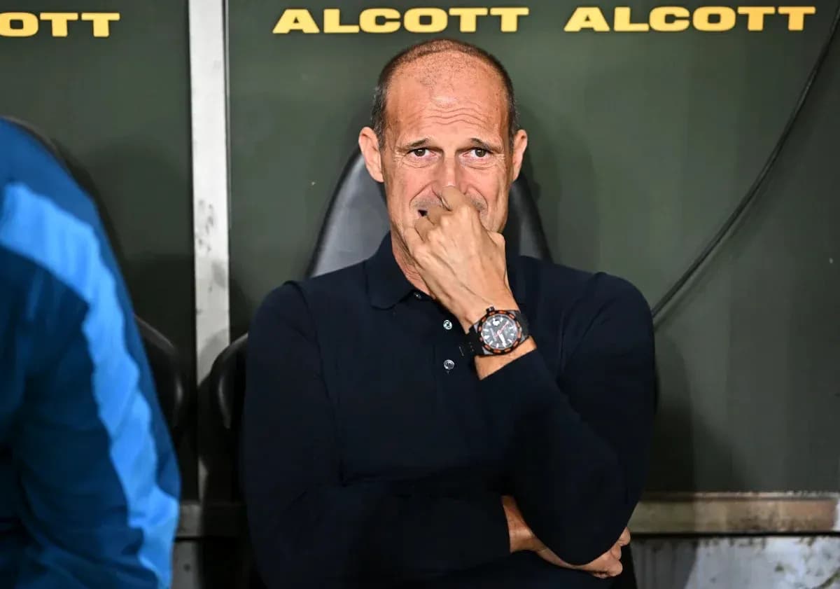 Coach seated on bench during match contemplation