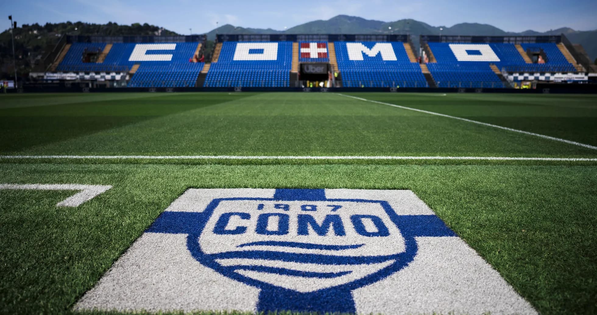 Como FC logo on the pitch with stadium seats