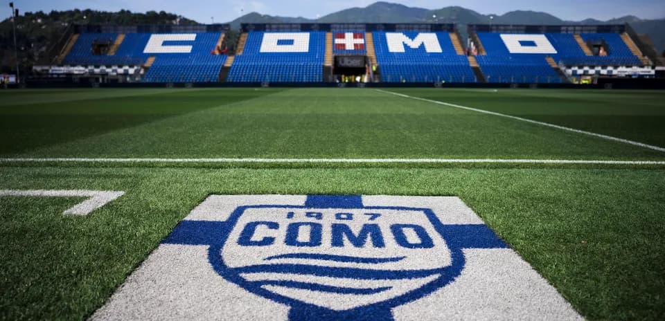 Como FC logo on the pitch with stadium seats
