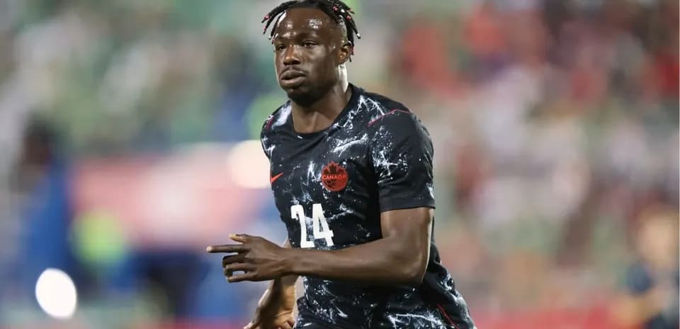 Player wearing Canada jersey during soccer match