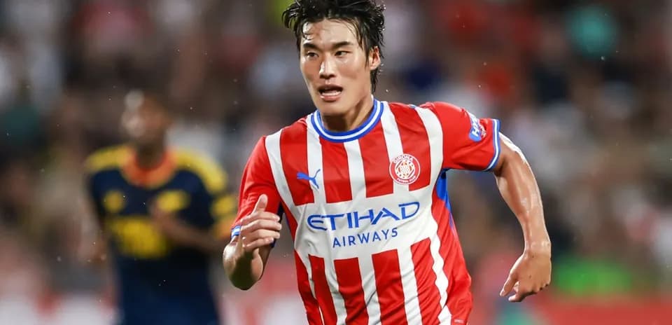 Player running during a football match for Girona