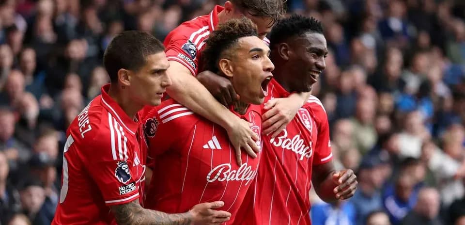 Players celebrating a goal in red jerseys