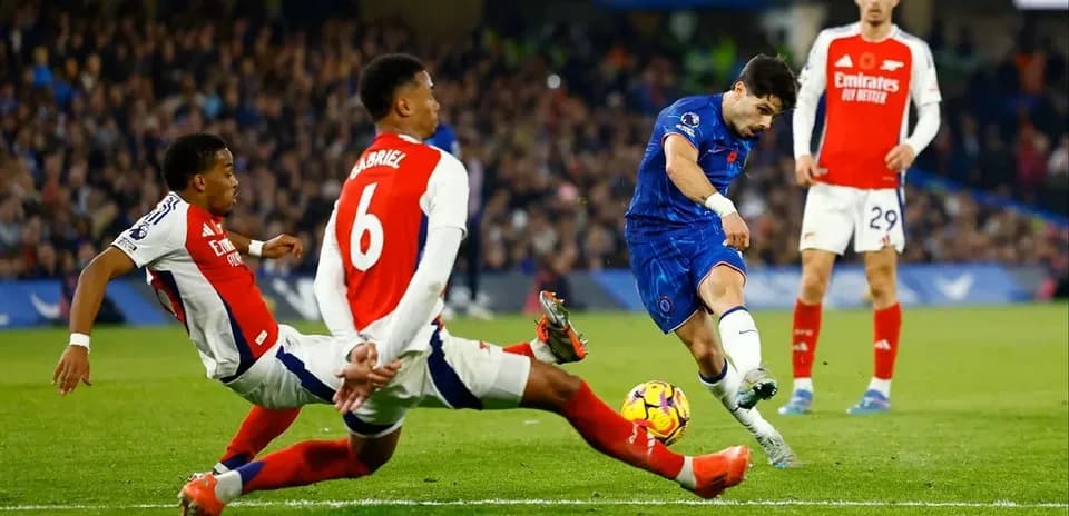 Chelsea player shooting on goal during match against Arsenal