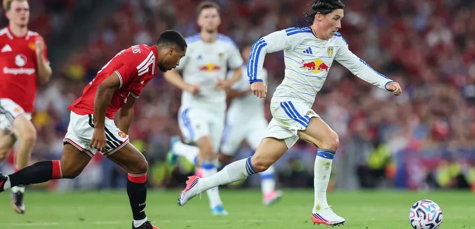 Leeds player sprinting past Manchester United defender