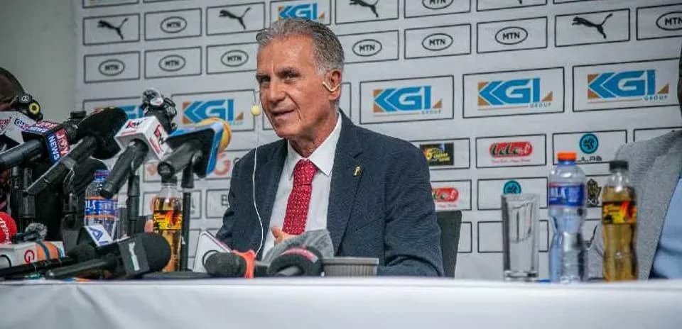 Manager speaking at press conference with microphones