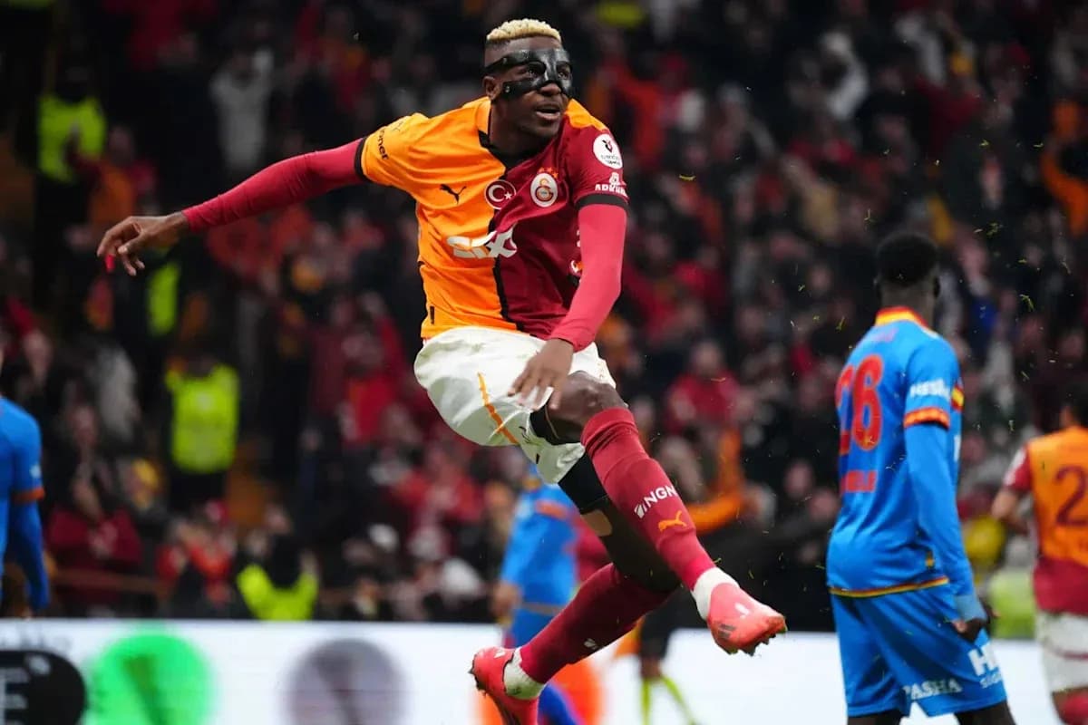 Player celebrating goal during match with fans in background