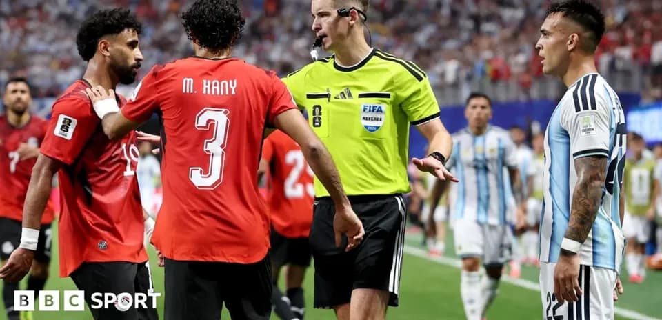 Players arguing with referee during match stoppage