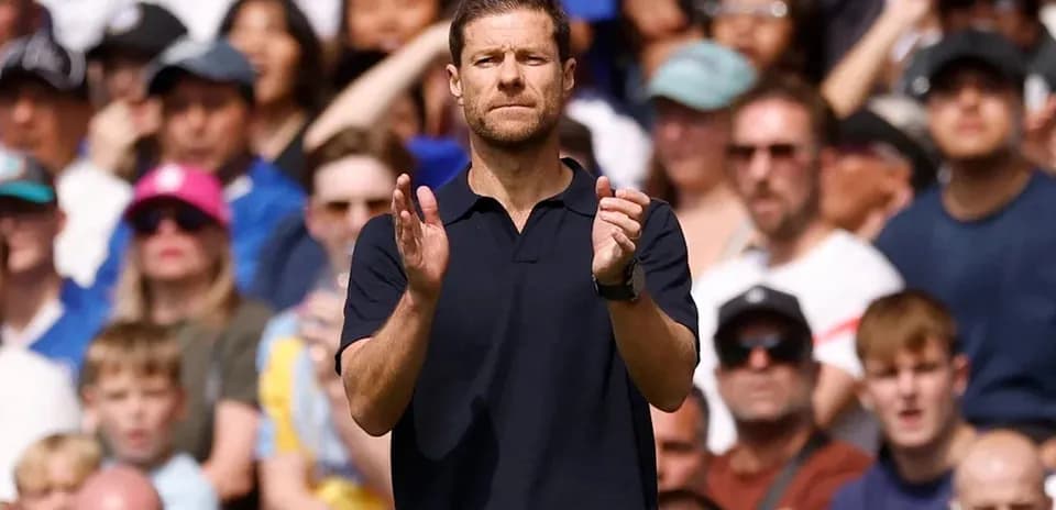 Coach applauding in front of cheering crowd