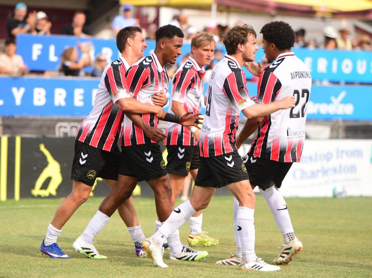Players celebrating a goal during USL Championship match