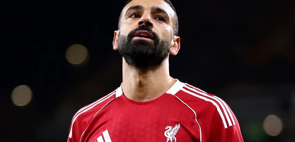 Player in Liverpool jersey looking upward during match
