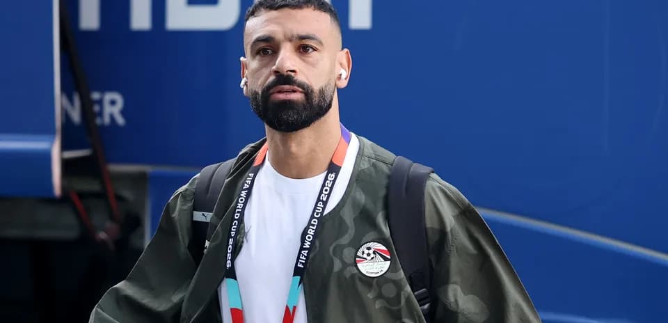 Player arriving with earbuds and FIFA credentials