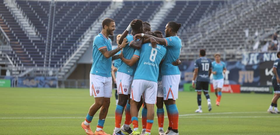 Miami FC players celebrating a goal