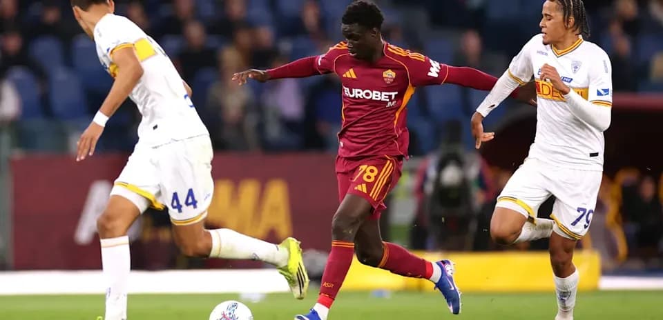 Player dribbling past opponents during match action