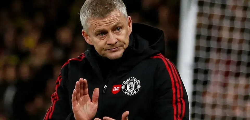 Manager gesturing during a match on the sidelines