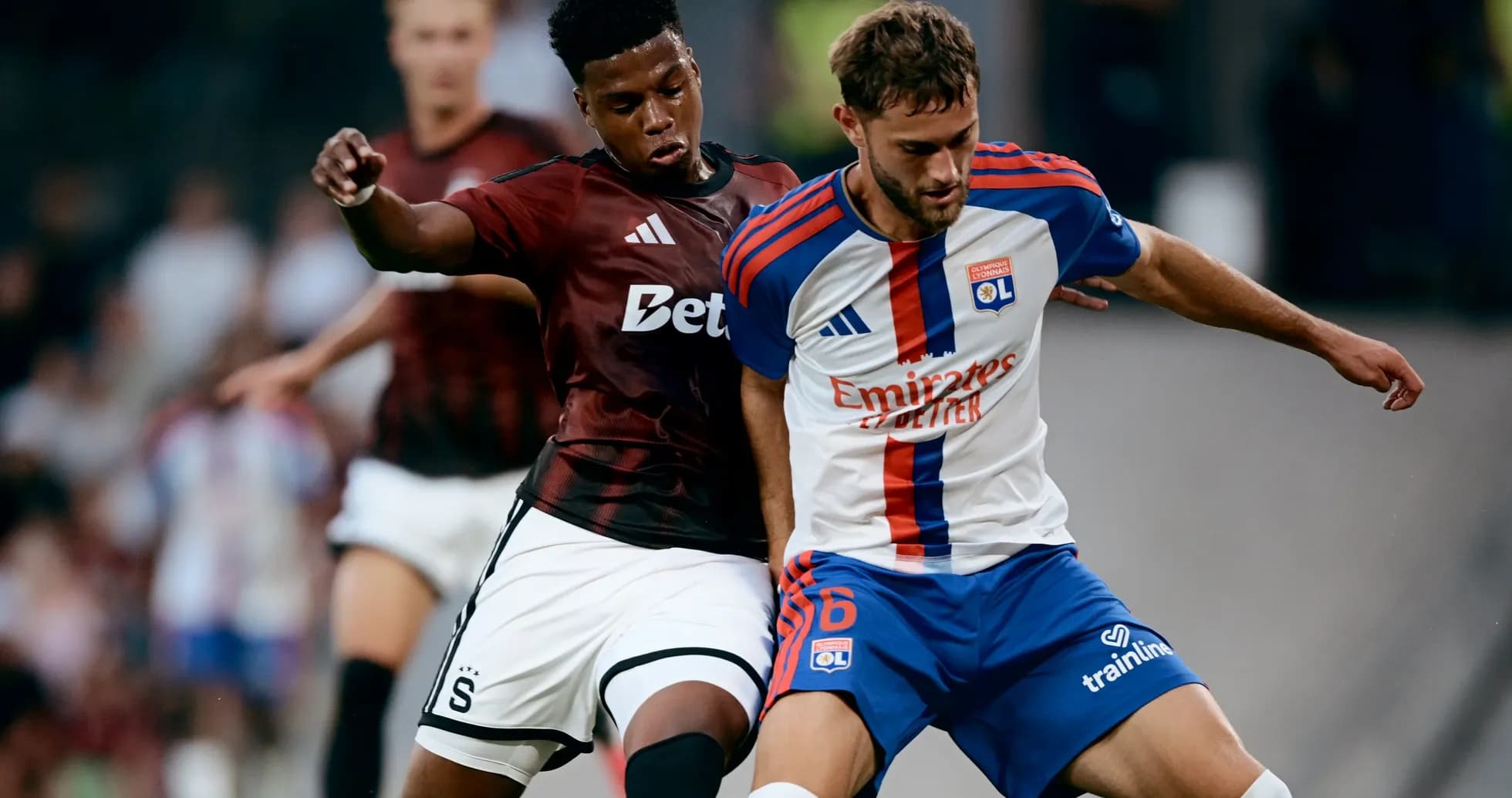 Sparta Praha player challenging Lyon player for the ball