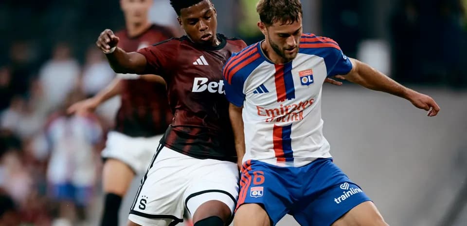 Sparta Praha player challenging Lyon player for the ball