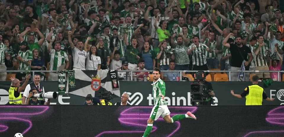 Player celebrating a goal with cheering fans