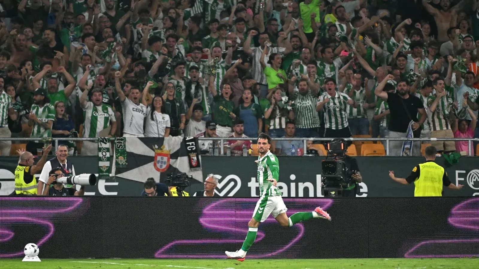 Player celebrating a goal with cheering fans