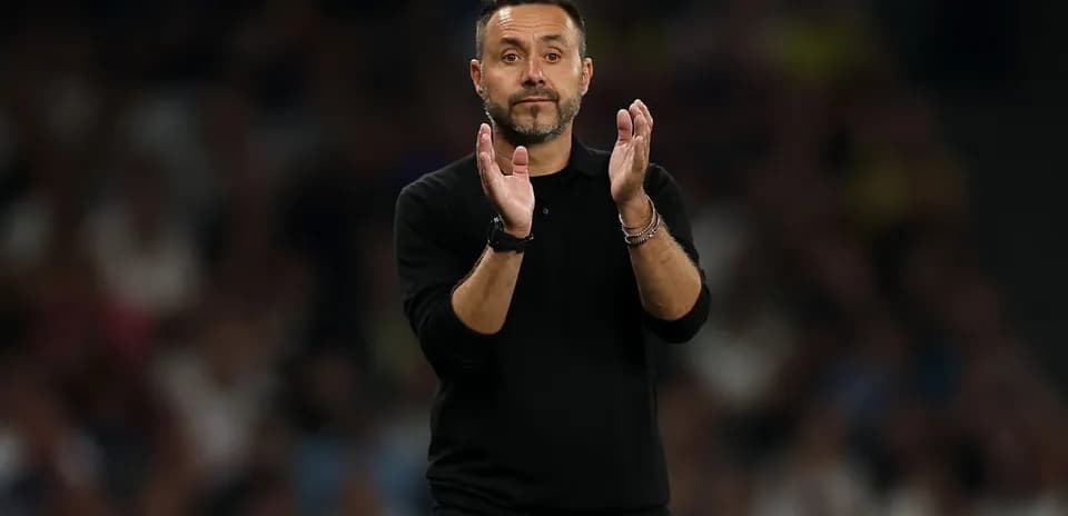 Coach applauding during a match on the sideline