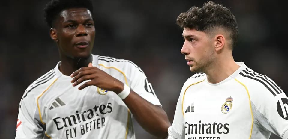 Two Real Madrid players discussing on the field