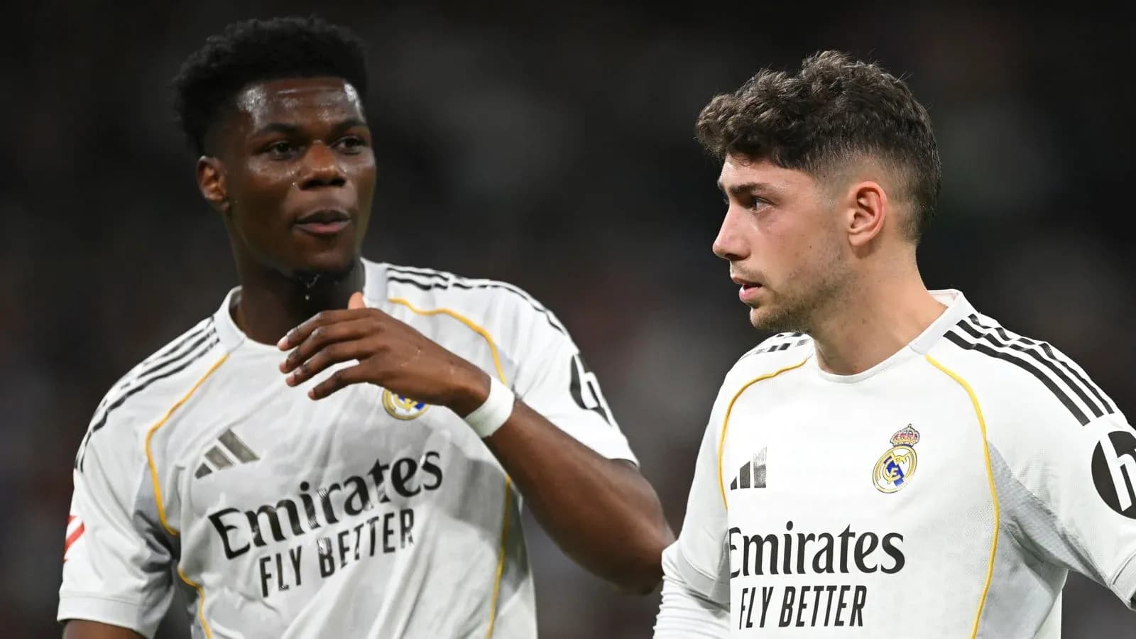 Two Real Madrid players discussing on the field