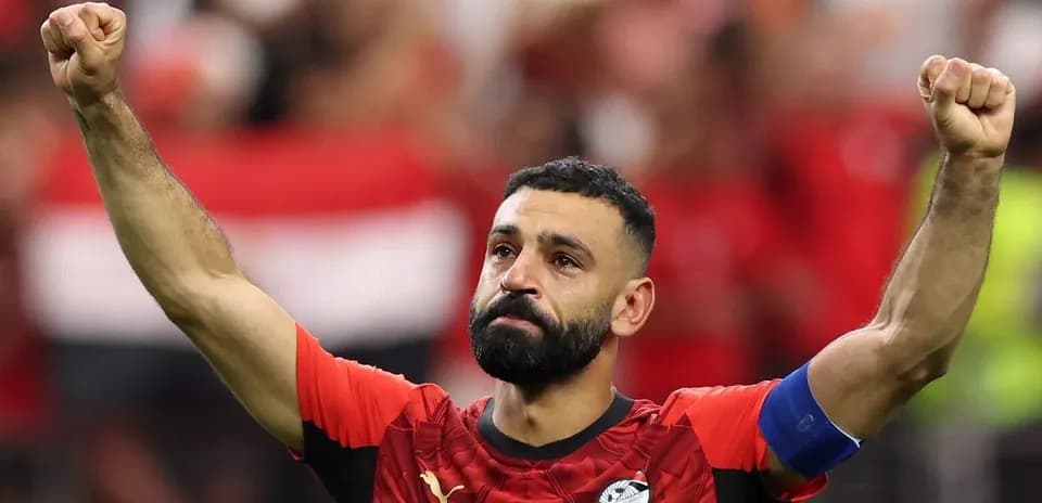 Player celebrating with raised fist in red jersey