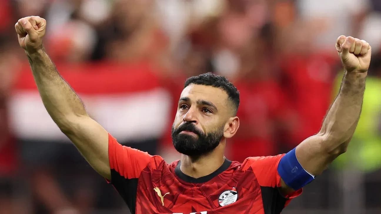 Player celebrating with raised fist in red jersey